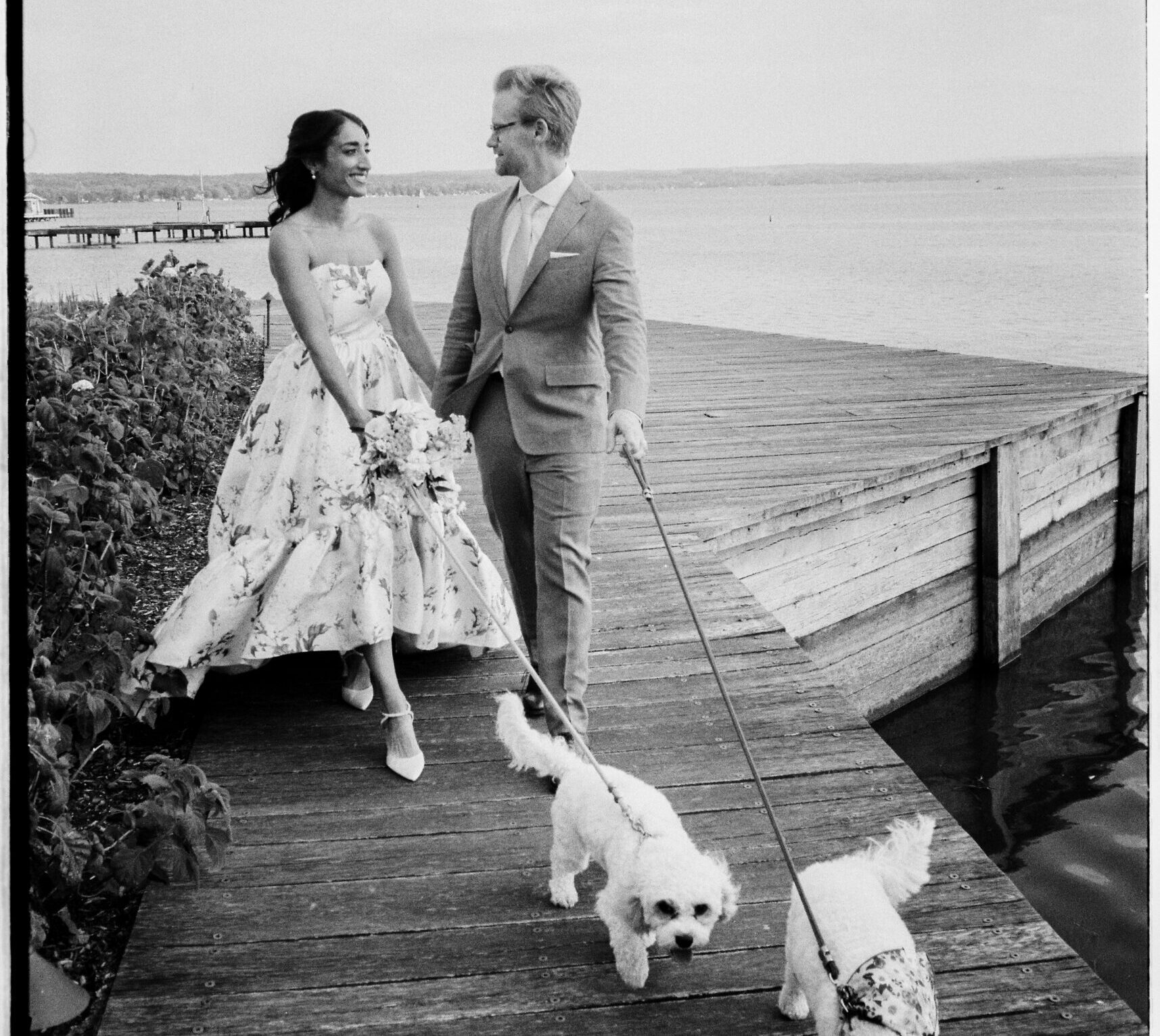 Bride and groom standing on the dock at The Lake House on Canandaigua during their intimate Thursday wedding.